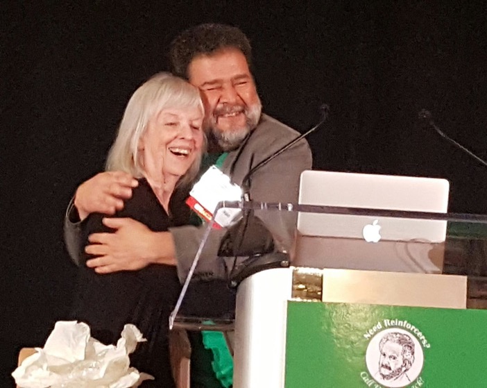 Karen Pryor and Dr. Jesús Rosales-Ruiz hug, after Karen receives the Anderson Award